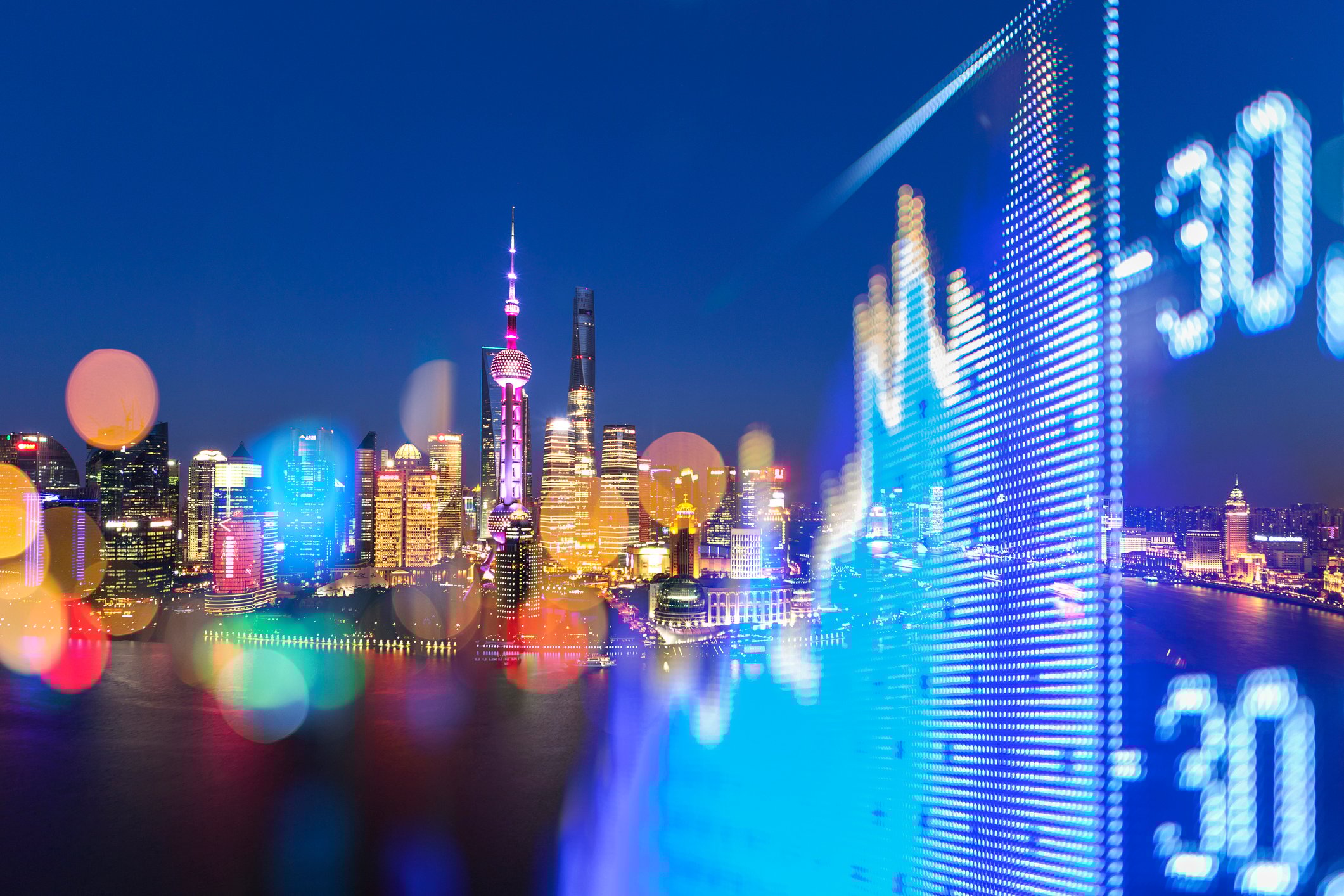 The Shanghai skyline with an overlay of a stock market chart.