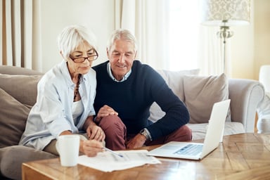 Two elderly people looking over finances
