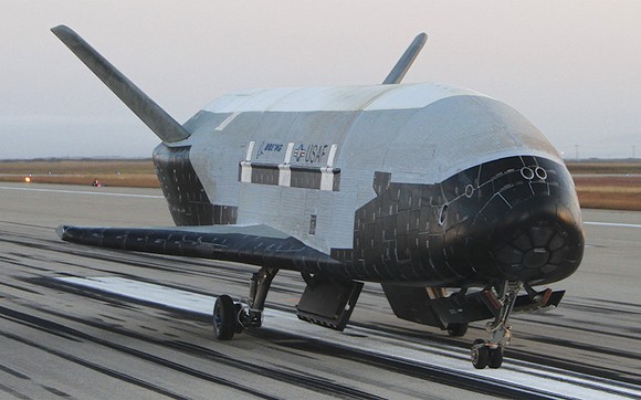 Boeing X-37B spaceplane landing on a runway.