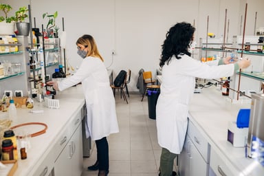 two scientists work at separate lab benches