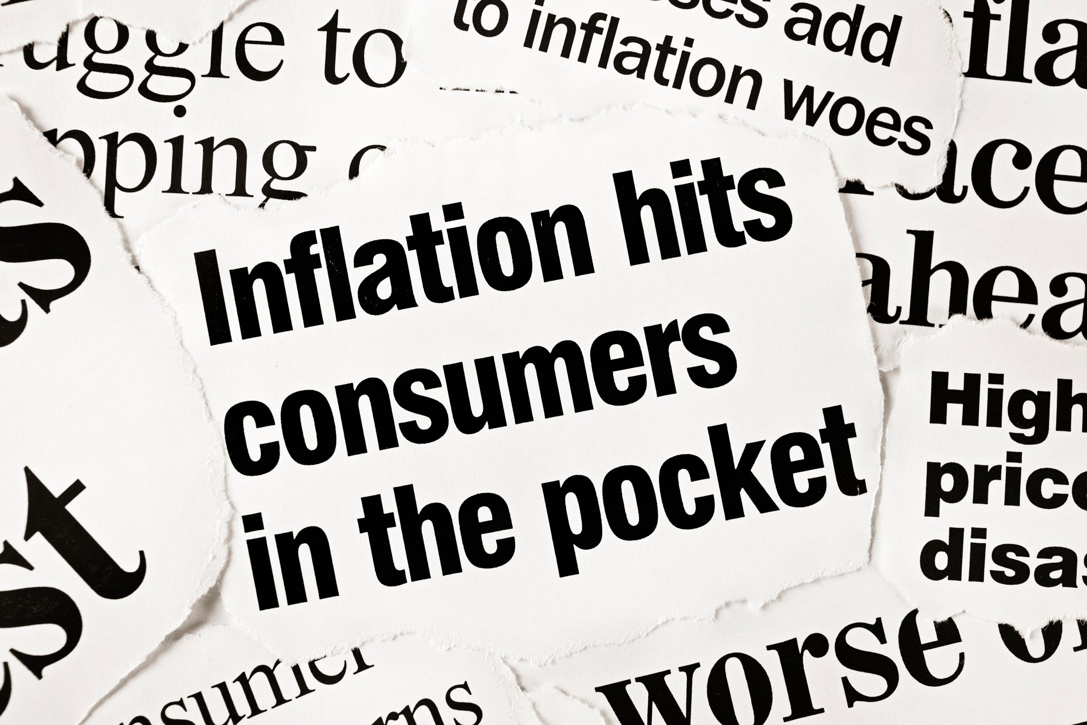 Newspaper clipping that reads "Inflation hits consumers in the pocket."