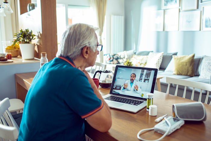 Doctor paying a virtual visit to an elderly patient. 