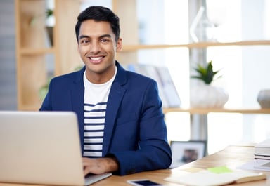 Smiling person at laptop_GettyImages-1159948727