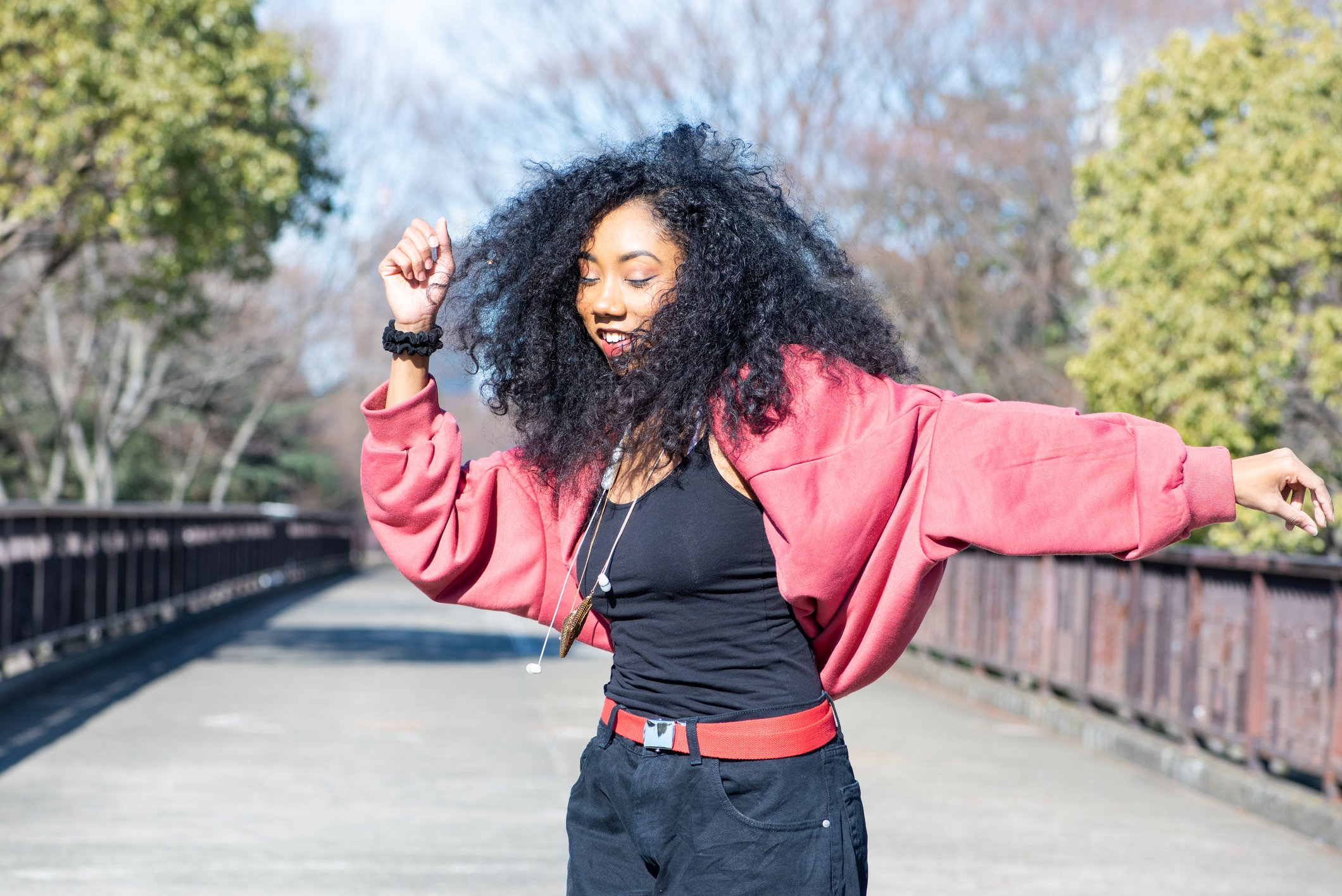Young person dancing outside at the park.