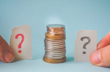 Stack of coins with question marks