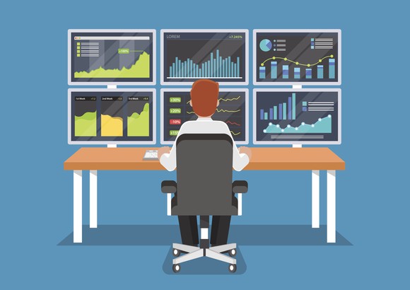 Man sitting at computer analyzing stocks.