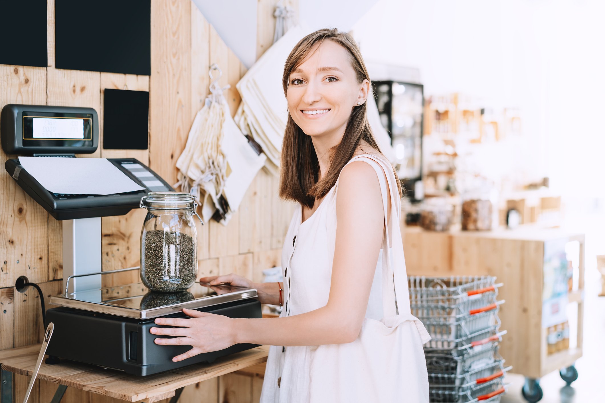 Person weighing product at a cannabis retail store.