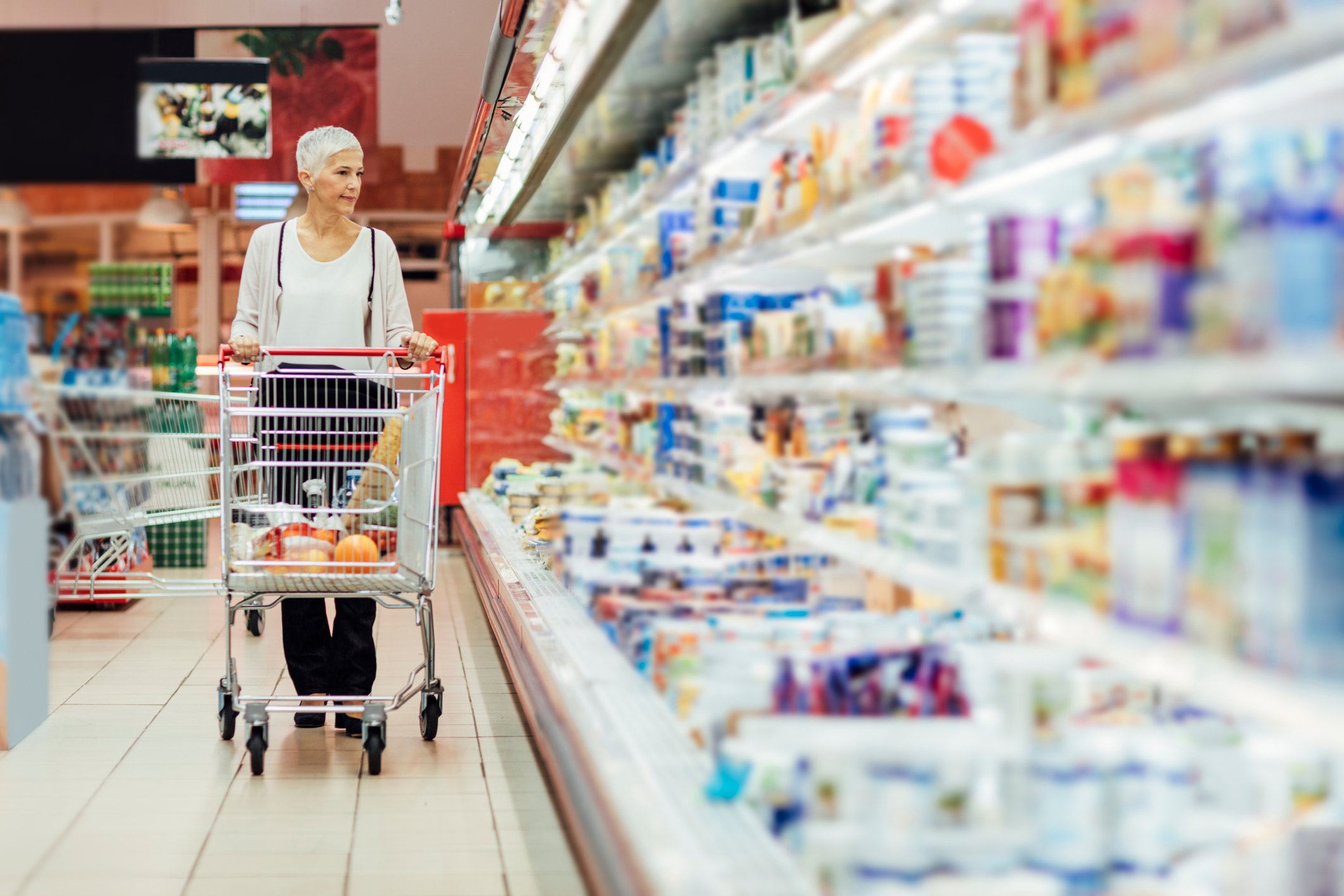 A woman shopping at a grocery store.