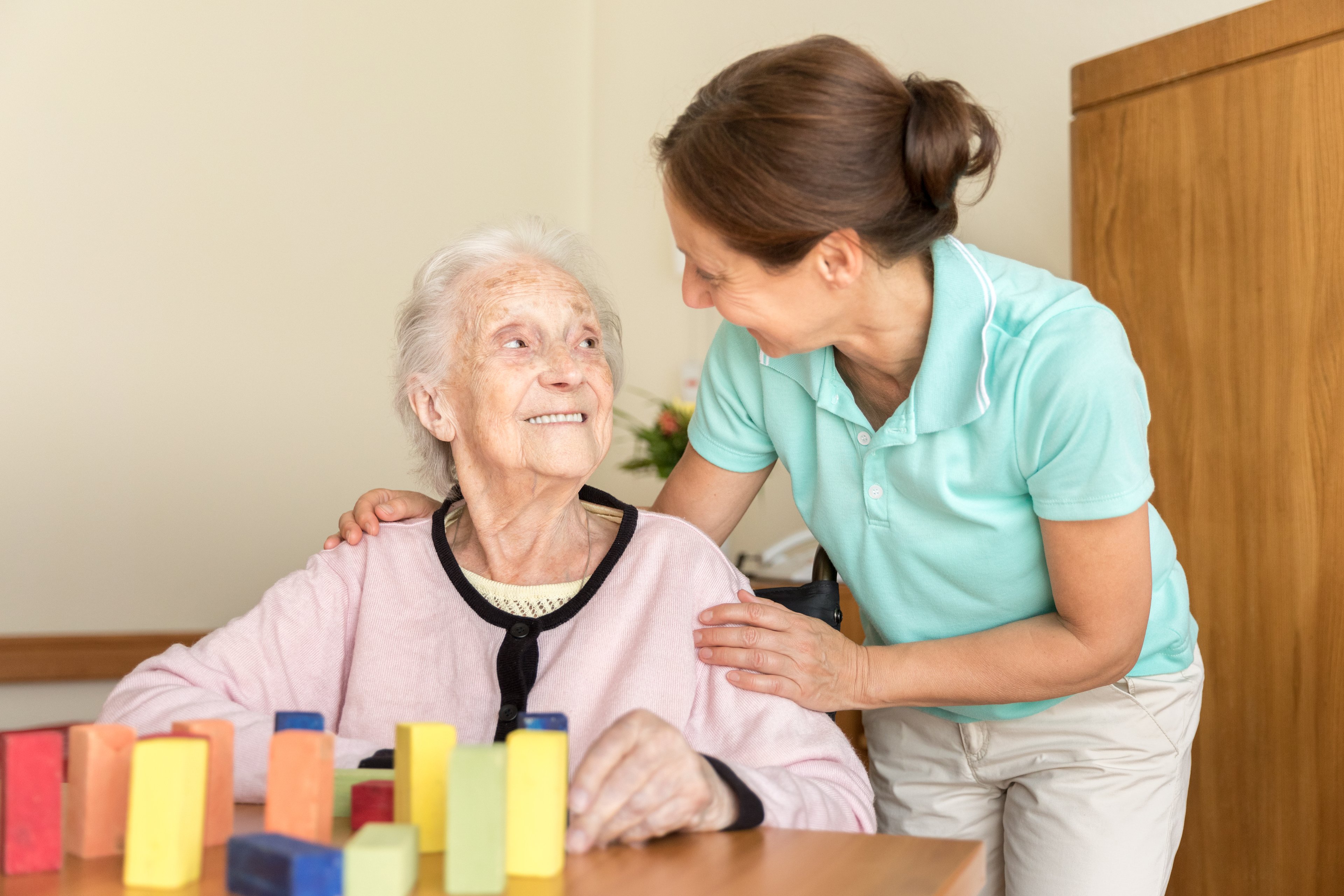 Nurse helping elderly patient in an assisted living facility. 