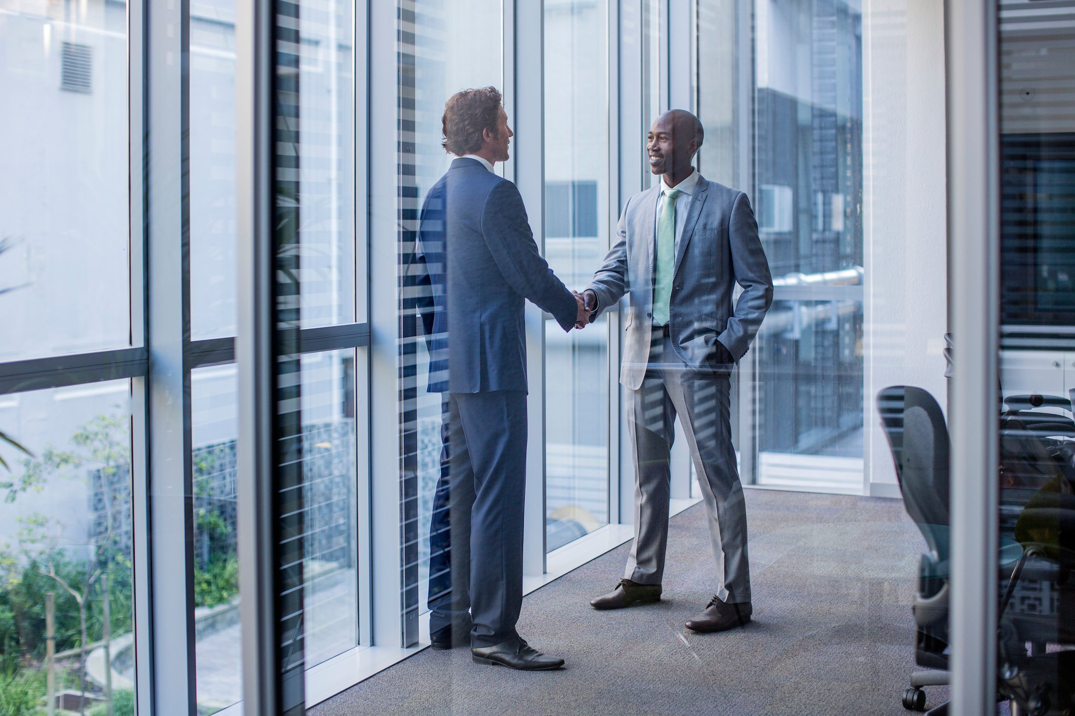 People shaking hands in an office setting. 