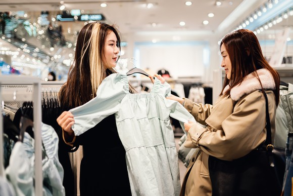Two women shop at a luxury boutique.