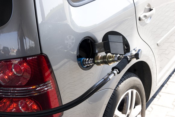 natural gas fuel behing pumped into automobile.