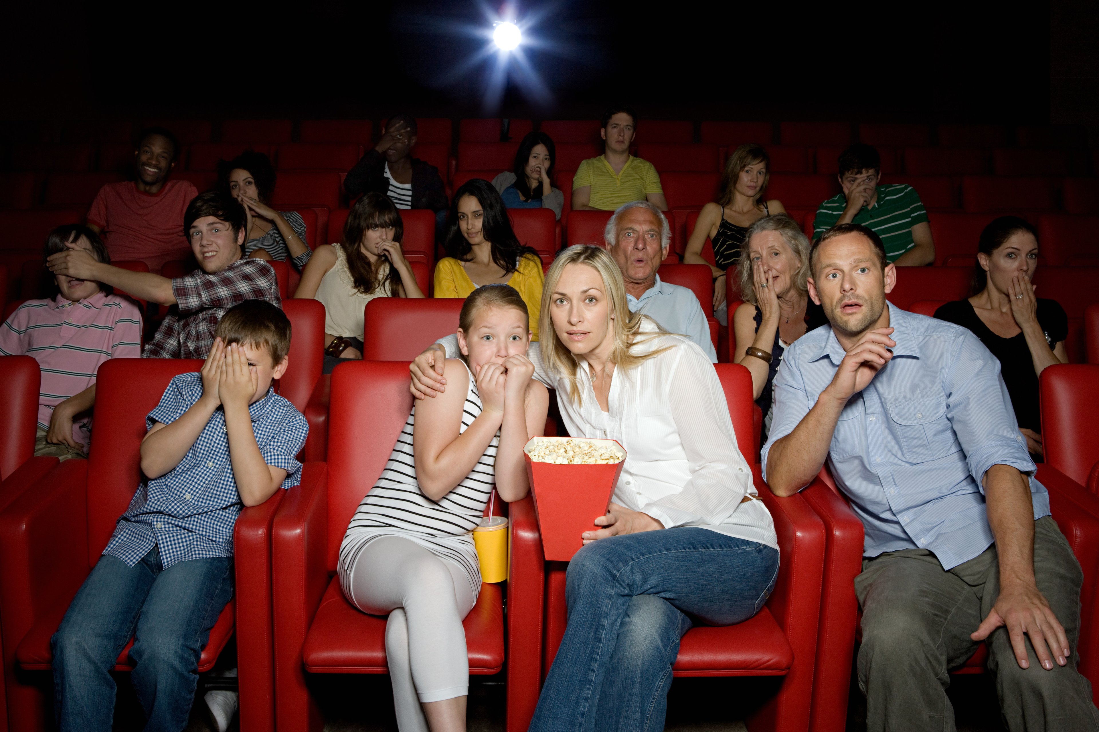 People enjoying a movie at the theater. 