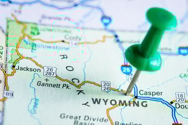 A push pin on a map of Wyoming.