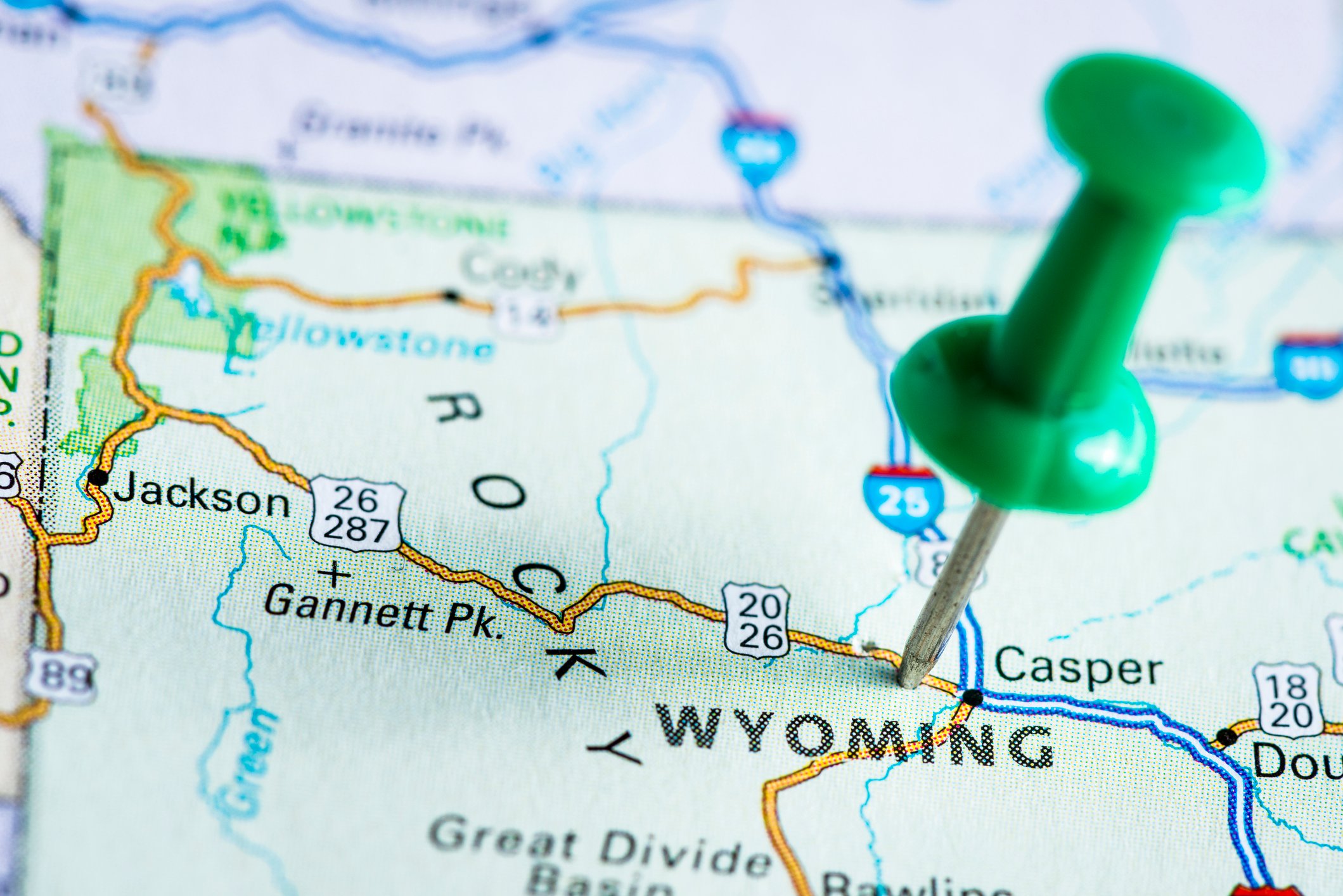 A push pin on a map of Wyoming.
