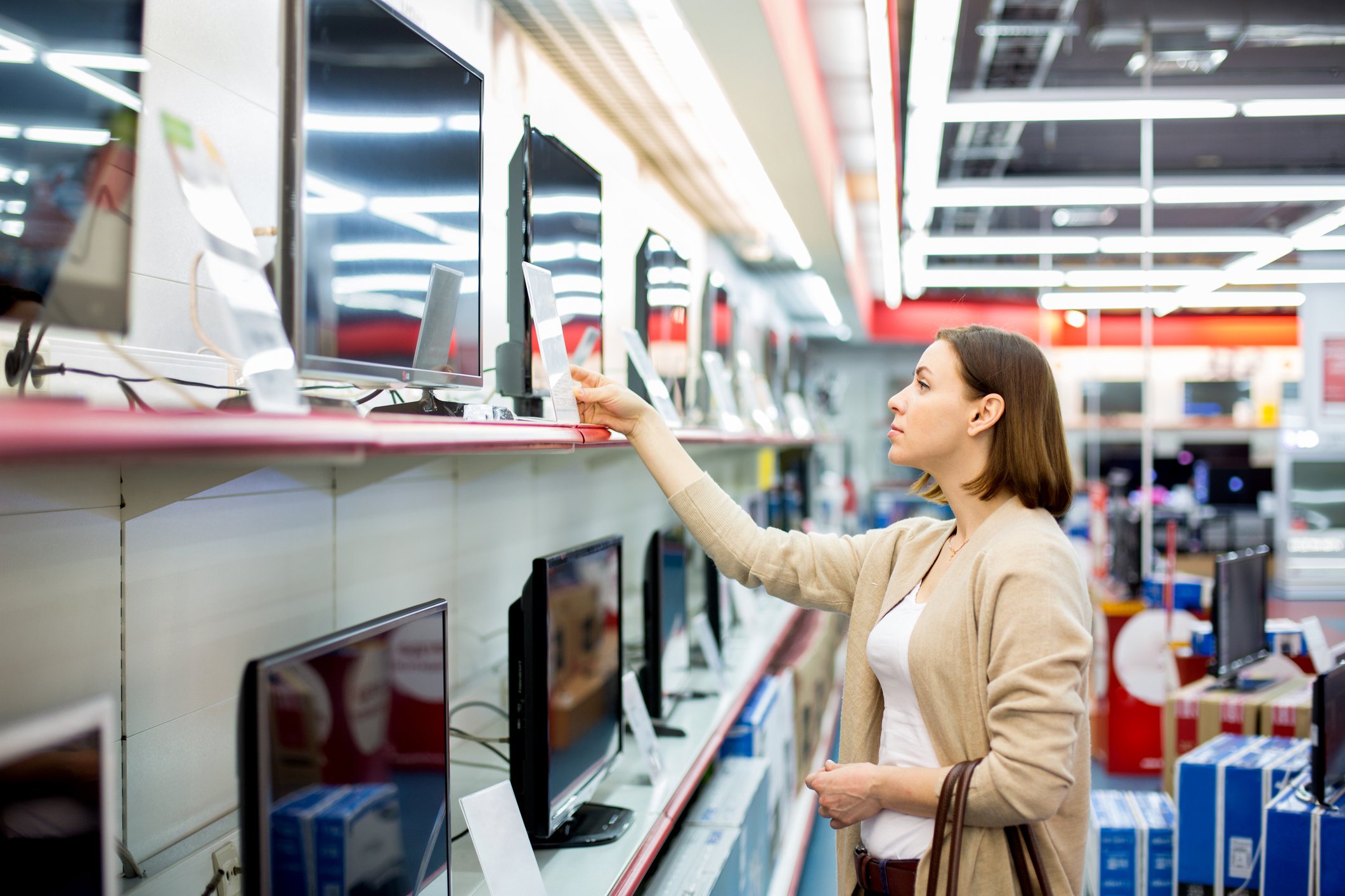 A woman shopping for a television set.