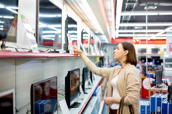 A woman shopping for a television set.