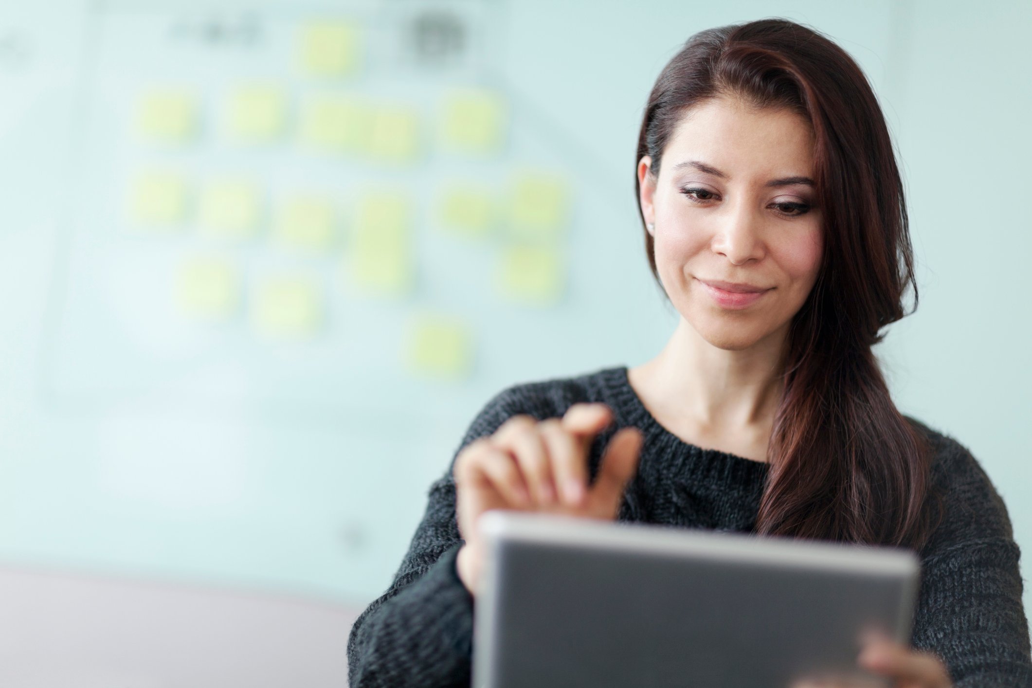 young woman holding hand over laptop