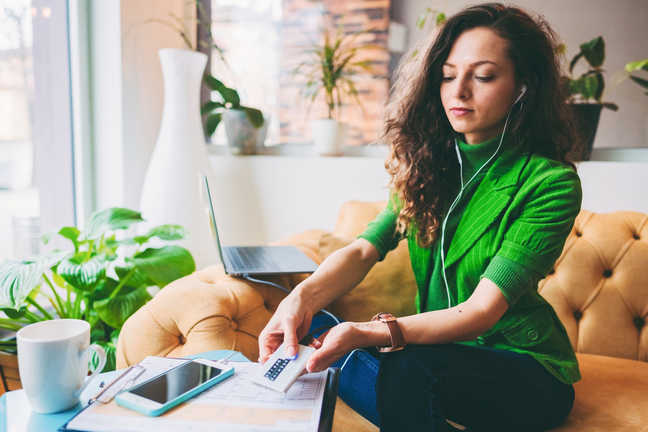 Person authenticating on her mobile phone using thumbprint.