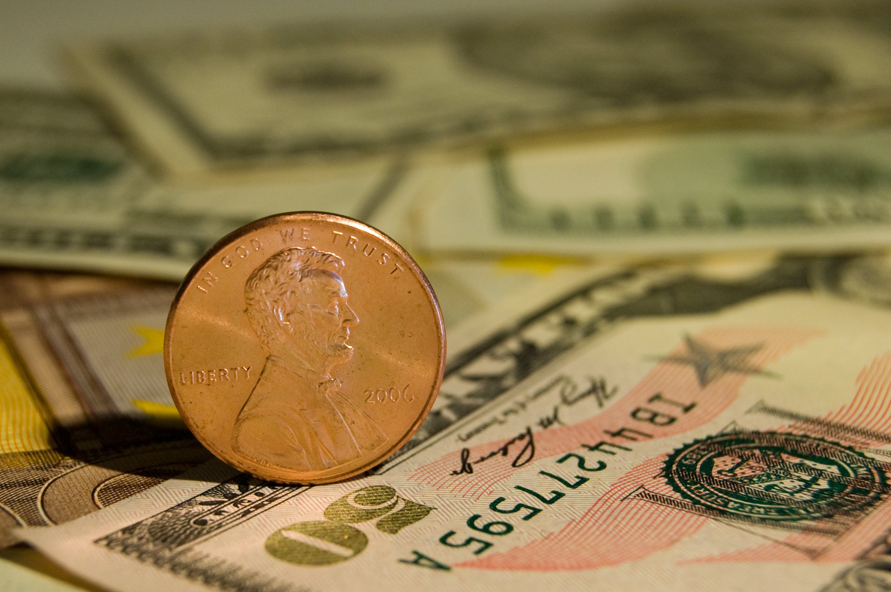 A penny on a pile of cash