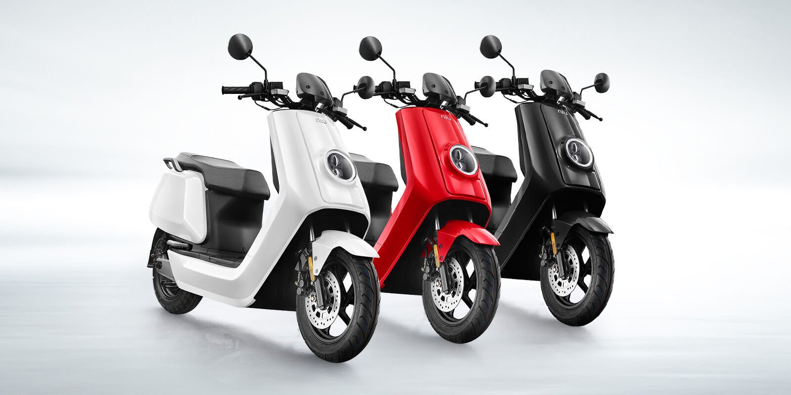 Three Niu electric mopeds.