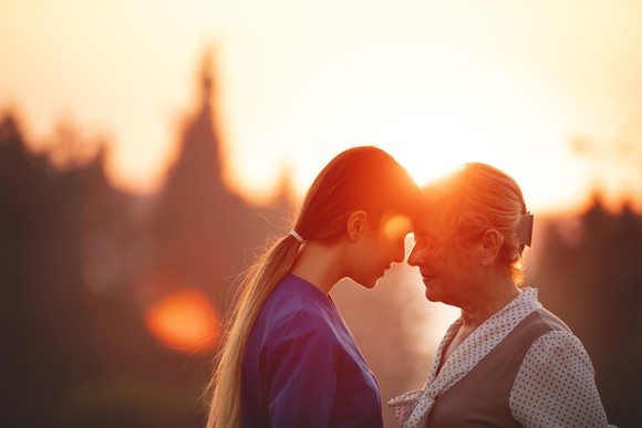 A daughter comforting her mother. 