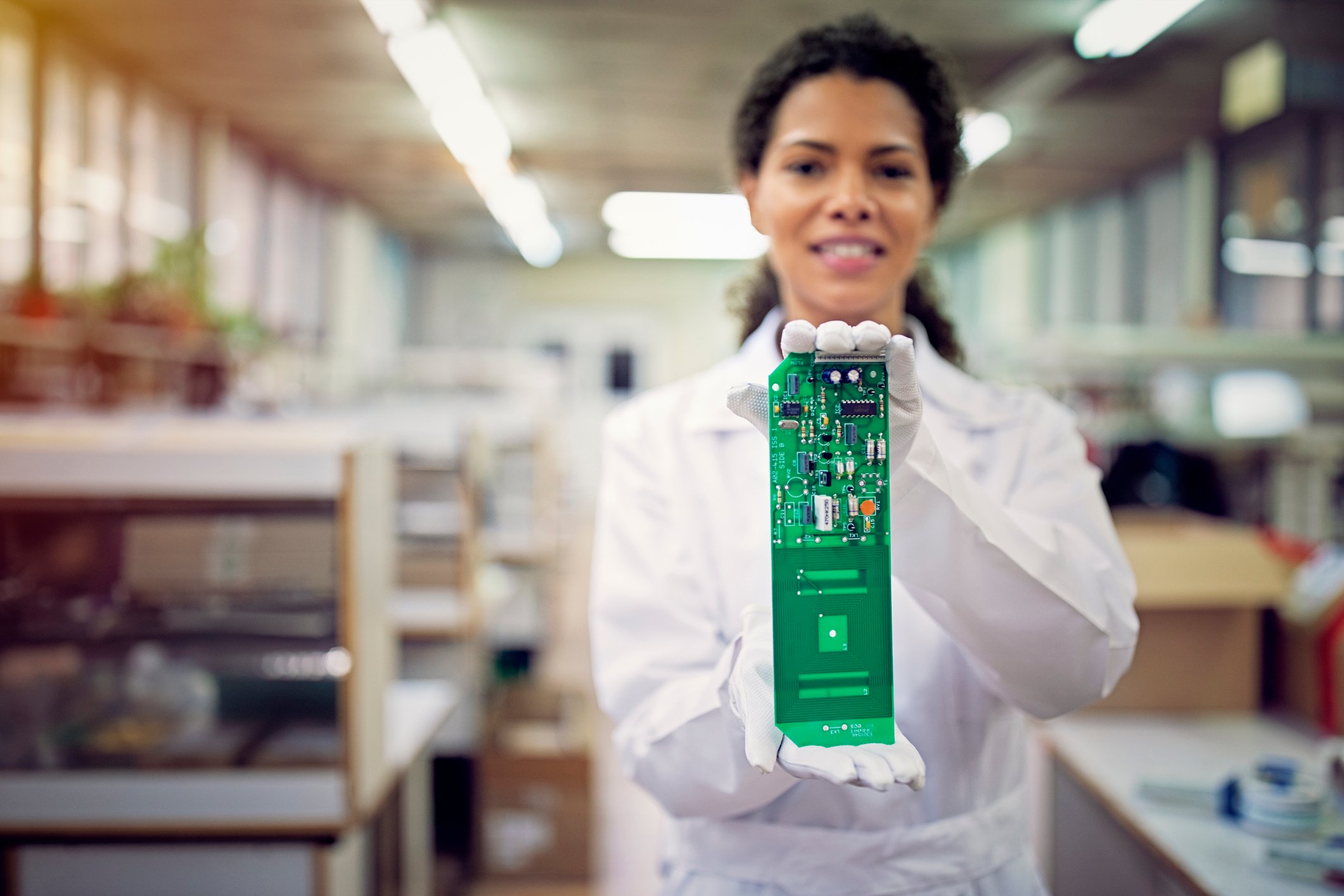 A person holding a circuit board.