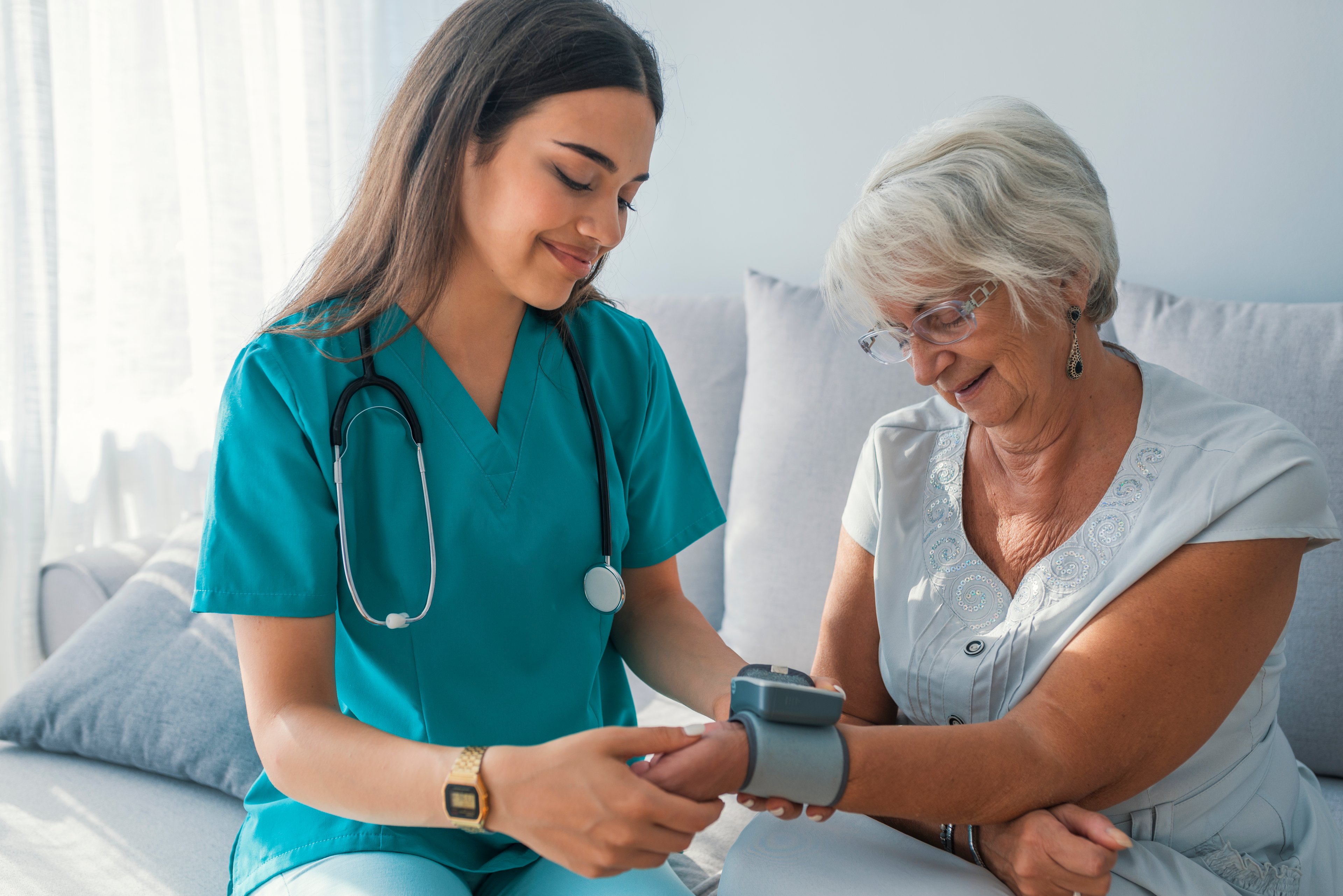 Nurse taking the blood pressure of patient. 