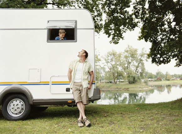 A man standing beside an RV.