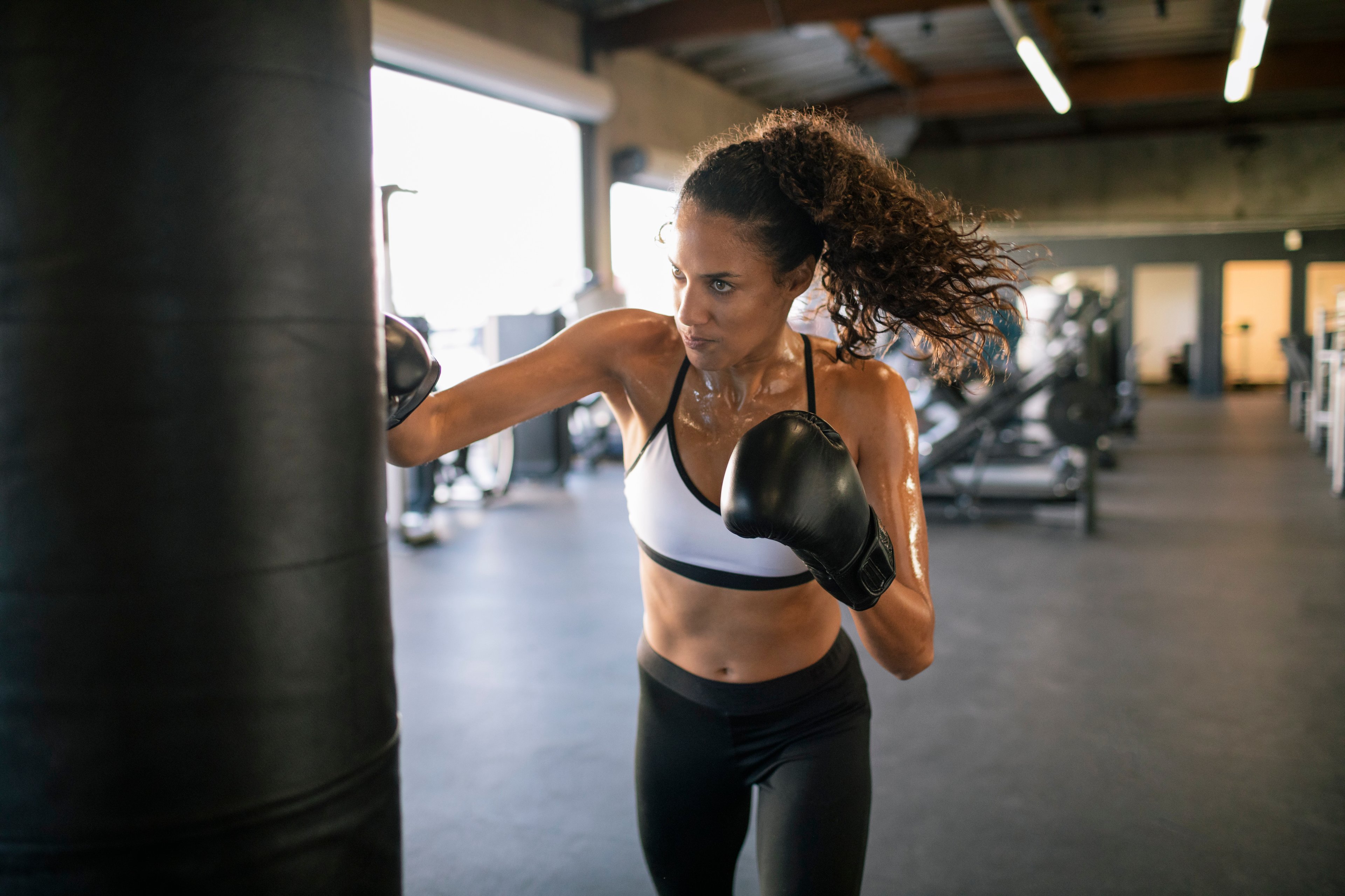 Boxer practicing on a punching bag.