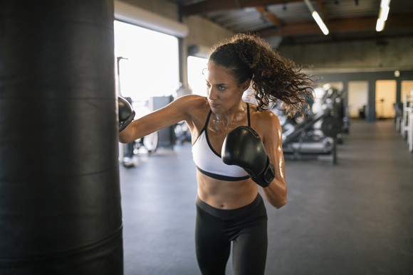 Boxer practicing on a punching bag.
