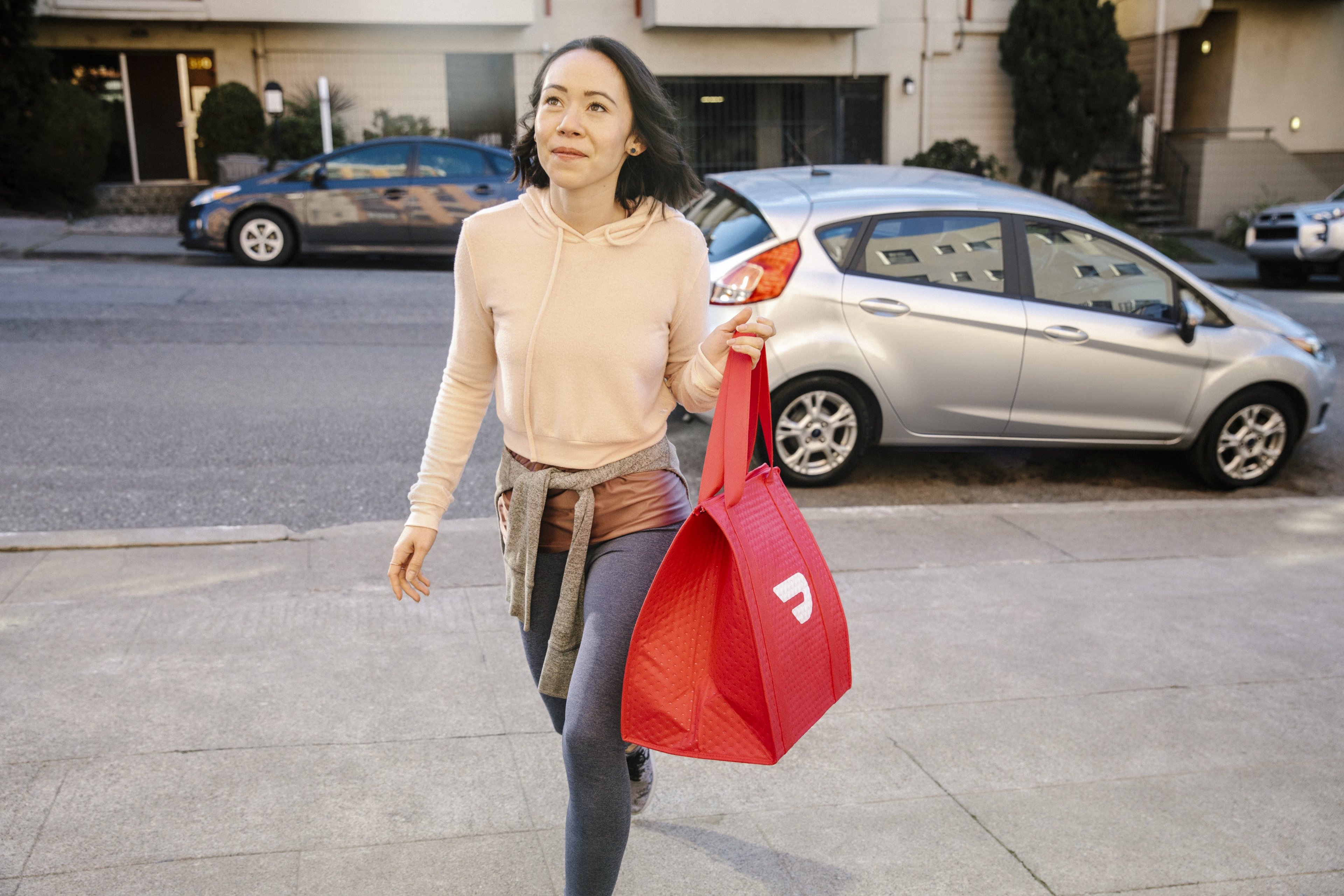 Woman carrying DoorDash bag