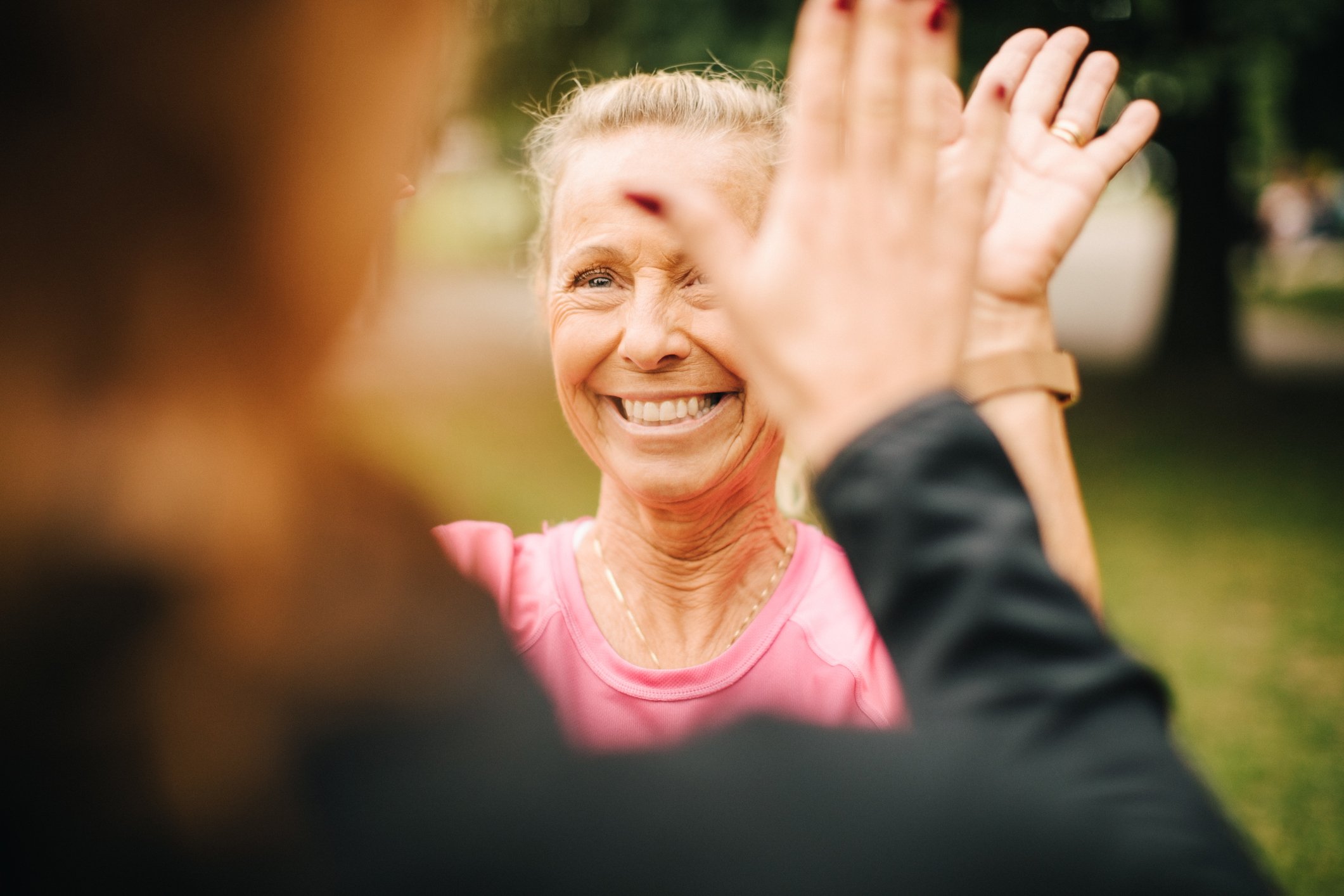 Two people high-fiving one another.