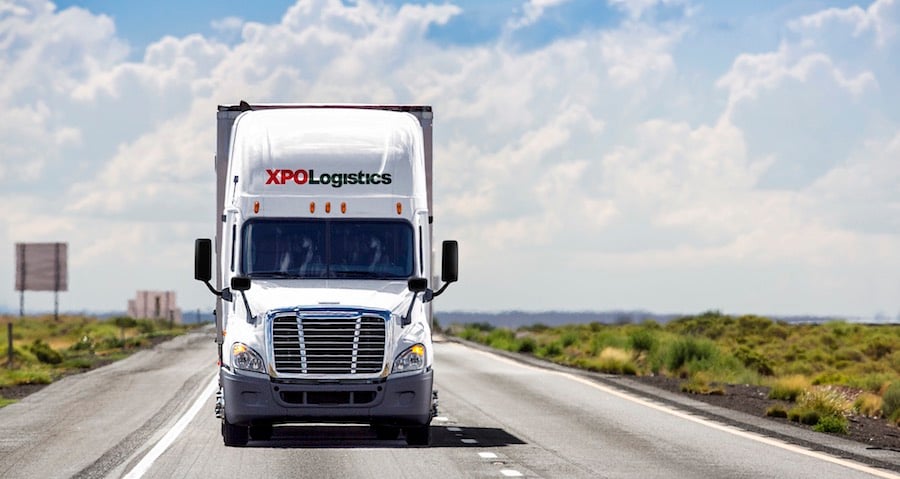 An XPO Logistics semi-trailer truck on the highway.