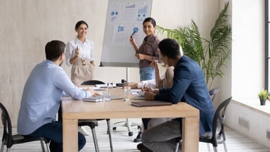 People in a meeting make a sales presentation.