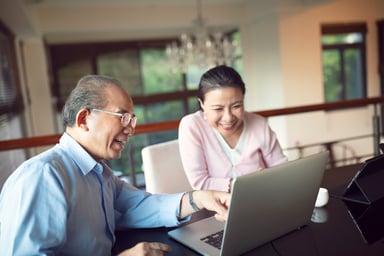 Smiling older couple with laptop