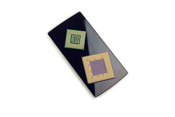 Smartphone chipsets atop a smartphone.