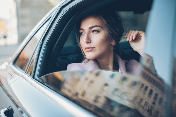 Woman looking out of car window. 