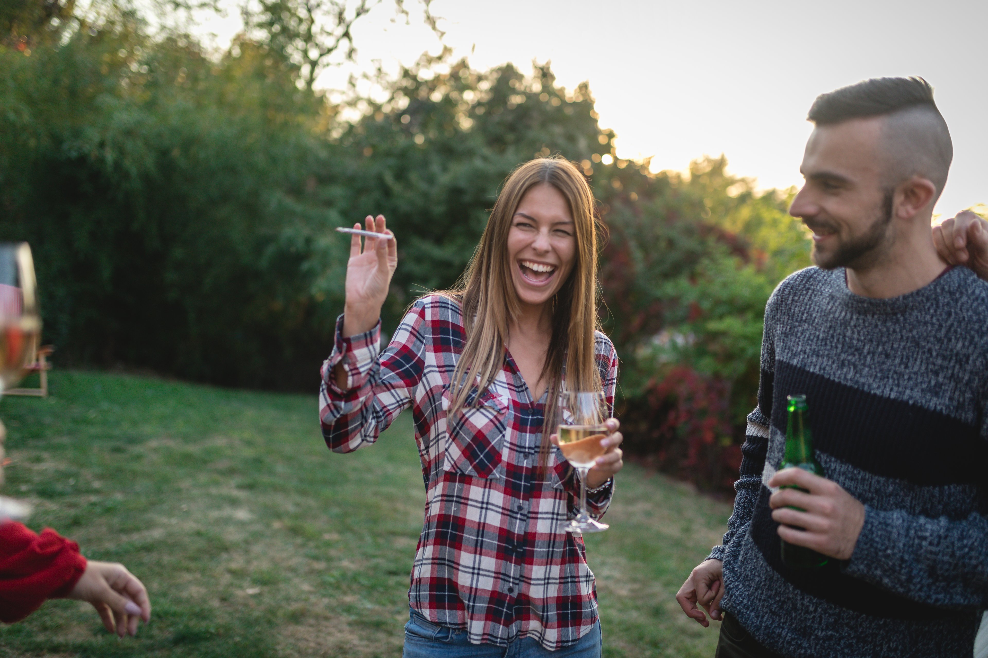 People smoking cannabis at an outdoor party. 