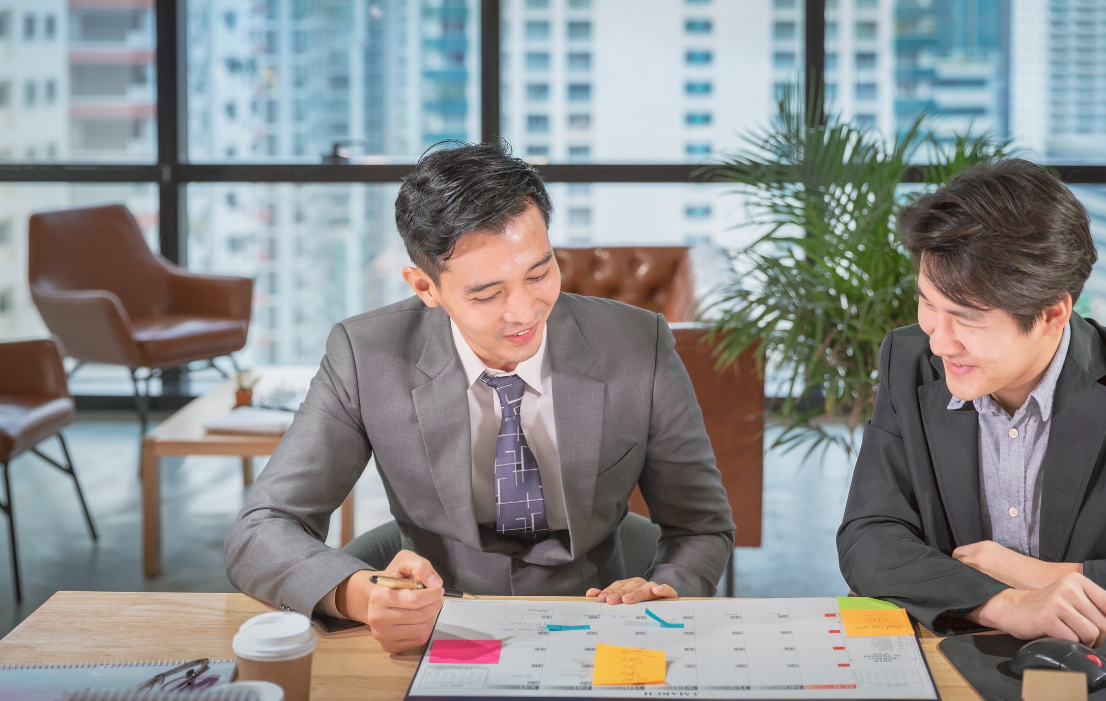 Two business people reviewing a calendar.