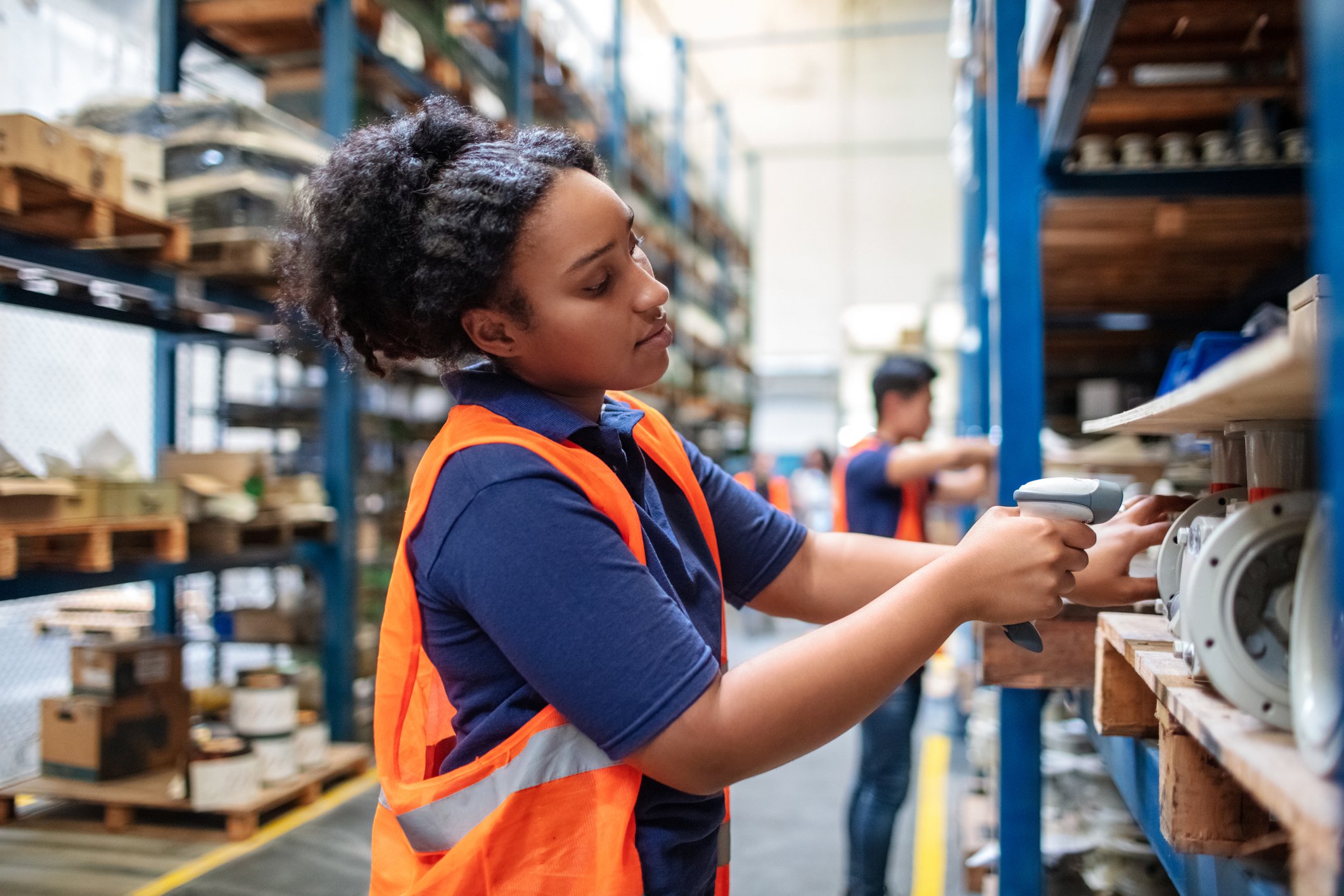 Person scanning items in a warehouse.