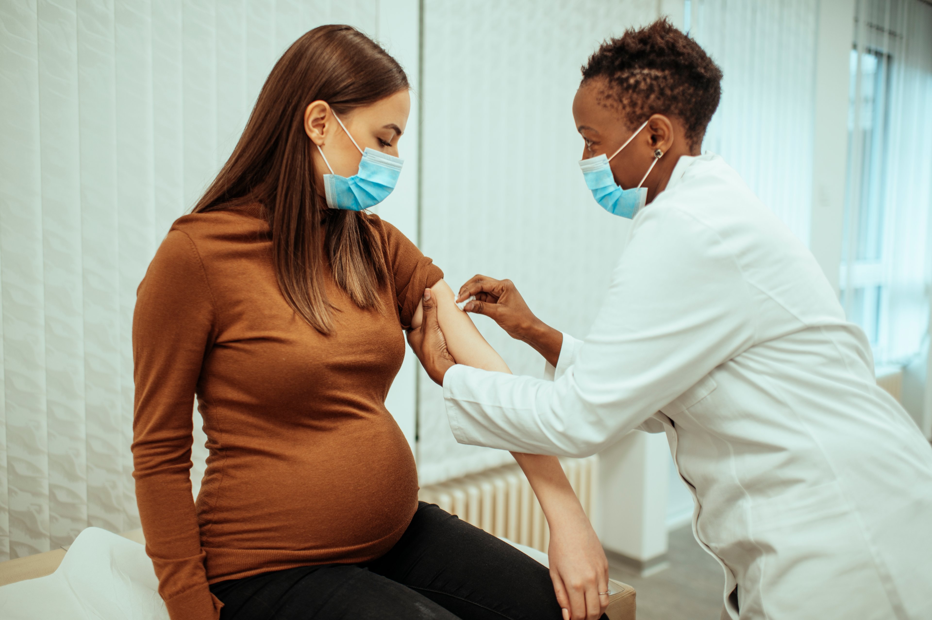 Patient receiving a vaccine from a doctor. 