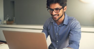 Smiling person at laptop_GettyImages-931734368