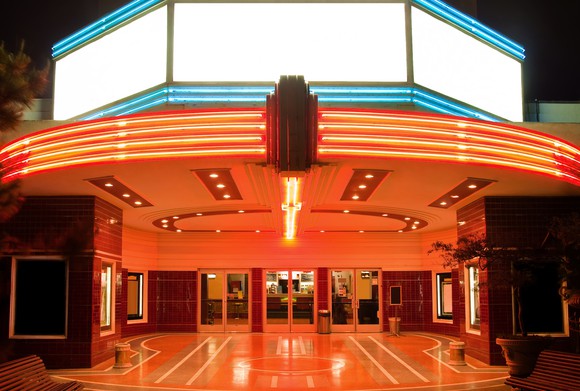 Neon lit exterior of a movie theater.