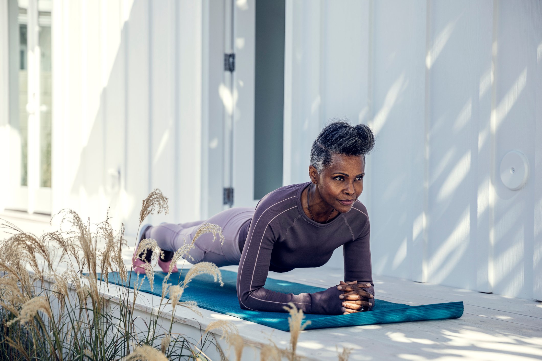 A woman doing yoga on a yoga mat.