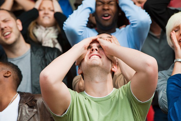 A crowd of people looking disappointed.