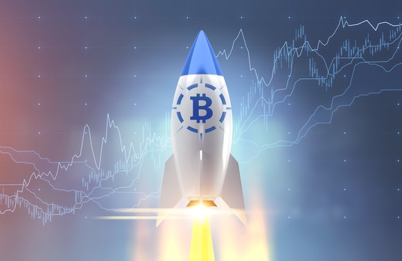 Rocketship with a Bitcoin emblem launching into space.