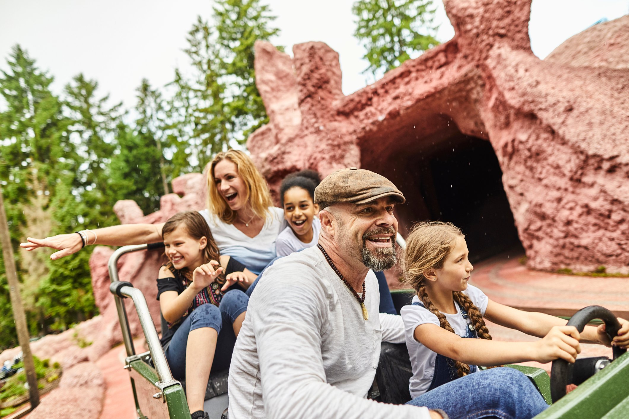 A family on a ride at a theme park.