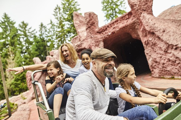 A family on a ride at a theme park.