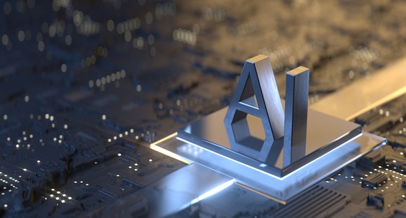A closeup of a computer chip, with the letters "AI" (artificial intelligence) carved in metal.